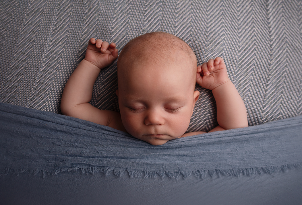 cute 3 month old baby photo lying on blue blanket asleep with arms up
